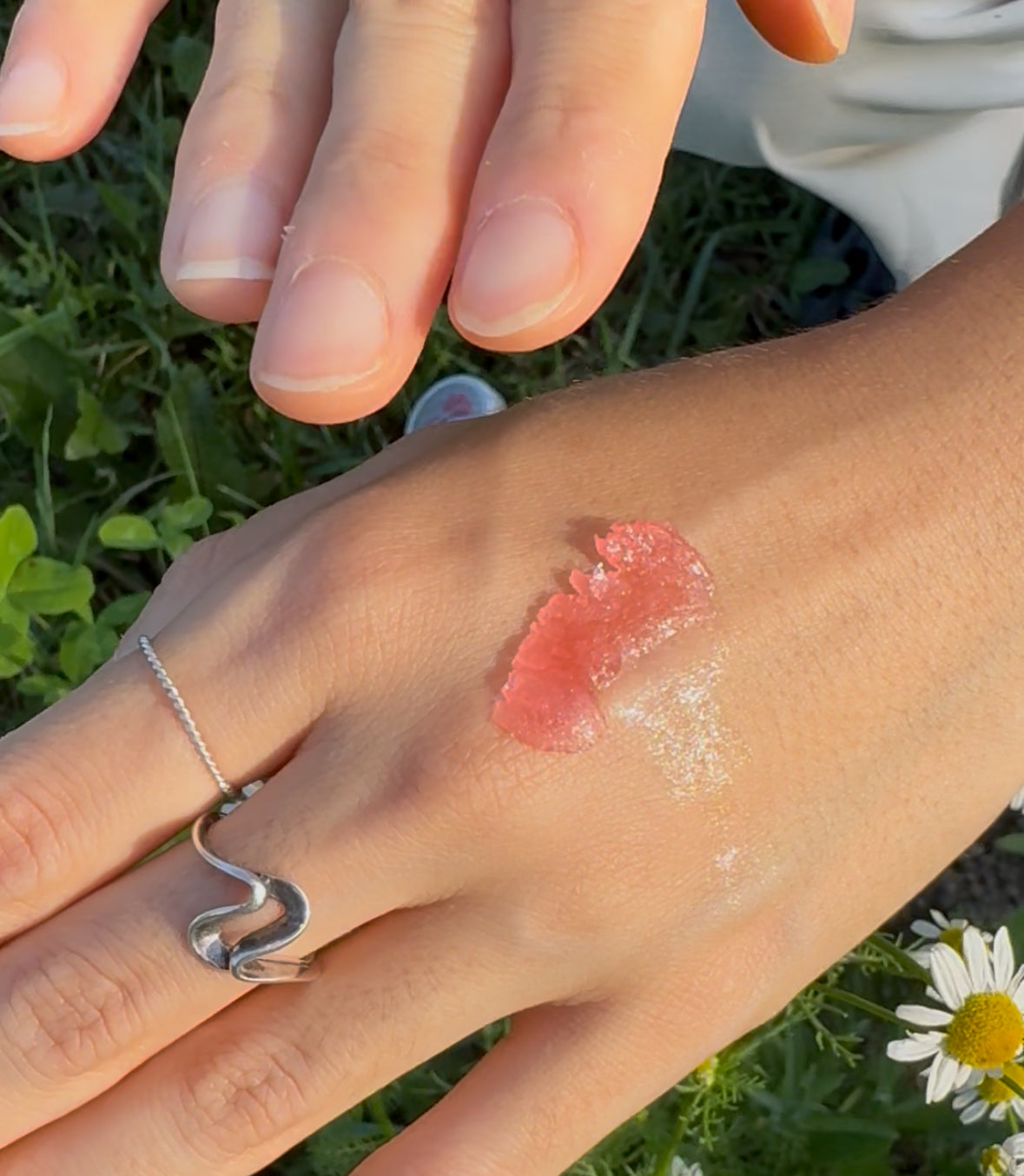 Texture swatch of Apis Apotheca CranJelly Pocket Balm ❃ for Lips, Cuticles & On-the-Go Skin Repair Hydration. Vegan Lip & Skin balm with cranberry seed oil & gromwell root. Deeply hydrating, soothing lip, cuticle & skin balm for dry, sensitive skin repair.